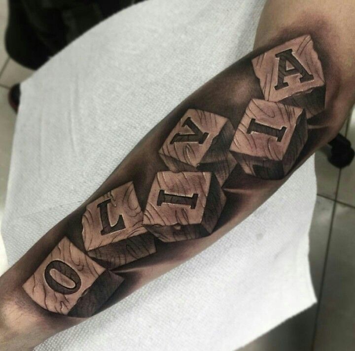 a man's arm with the word love written on it and blocks in black ink