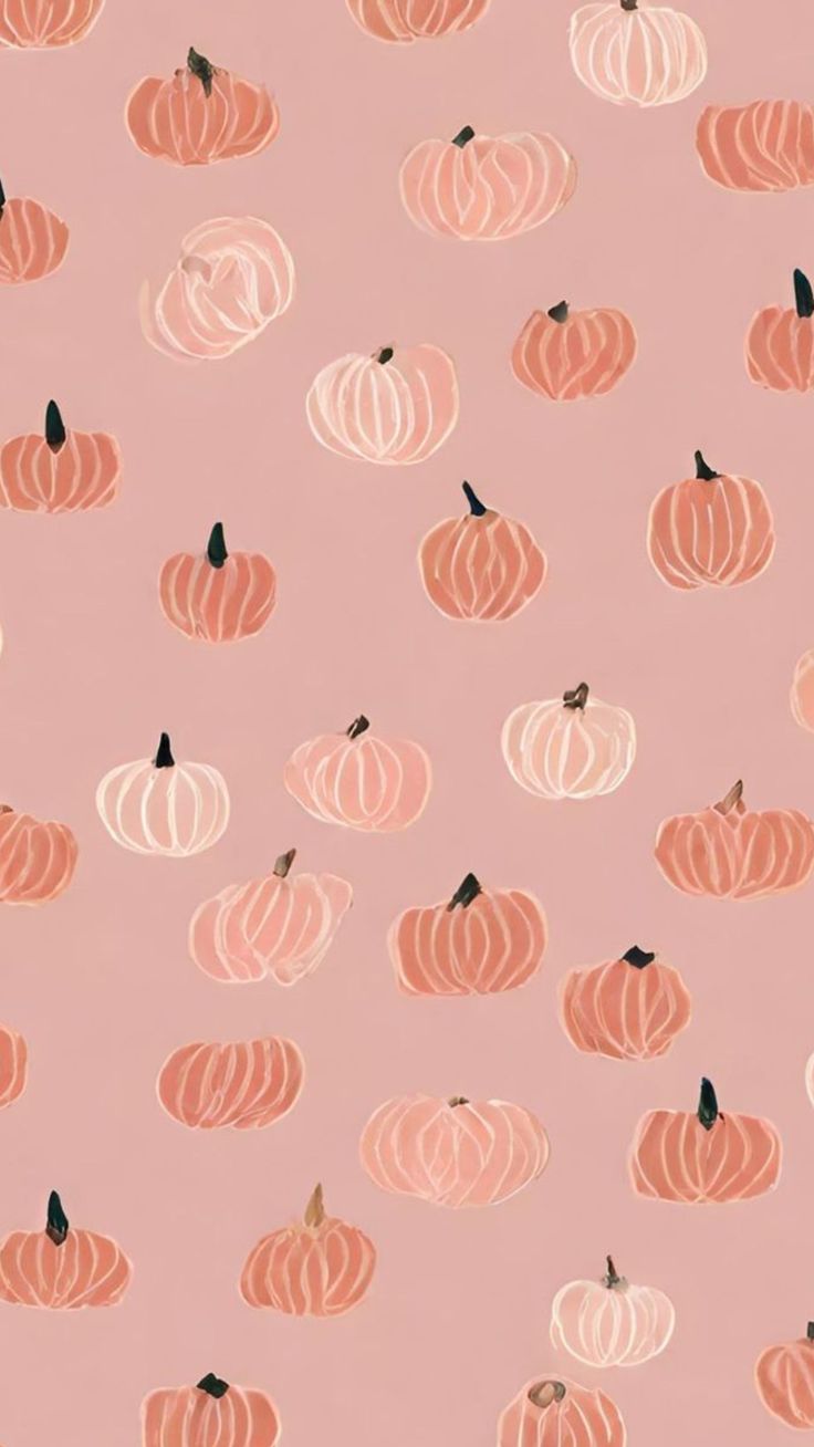 a pink background with orange and white pumpkins