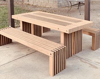 two wooden benches sitting next to each other on a sidewalk