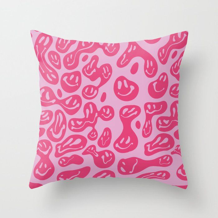 a pink leopard print pillow on a white wall