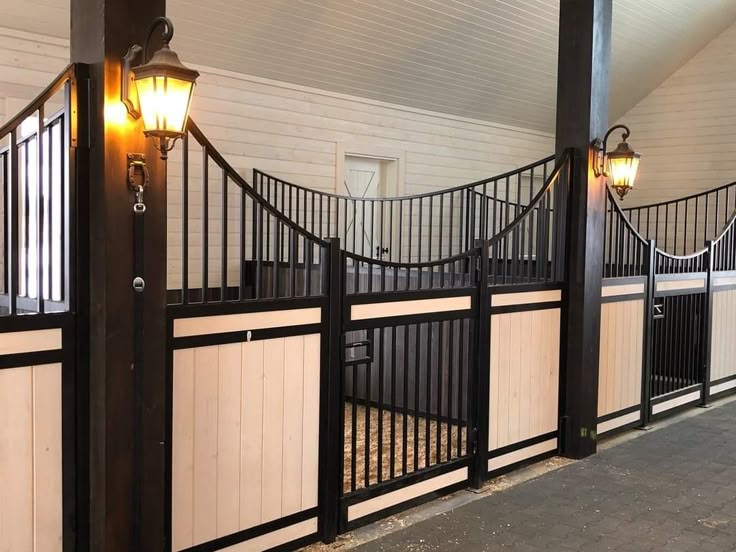 the inside of a horse stable with lights on