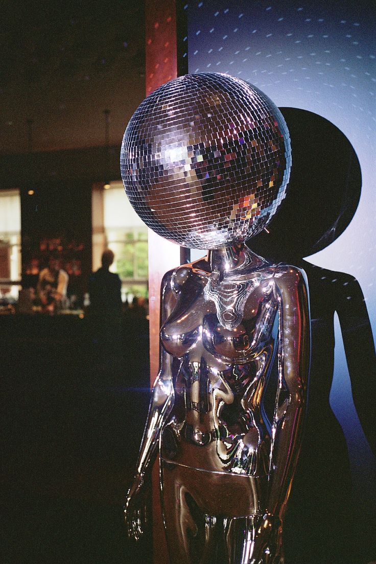 A mirror ball head Disco mannequin prop at a wedding reception room Disco Ball Mannequin, Disco Ball Hallway, Disco Party Inspiration, Disco Party Props, Disco Ball Sculpture, Dark Disco Aesthetic, Modern Disco Aesthetic, Disco Mannequin, Hedonistic Disco