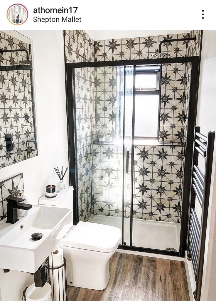 the bathroom is decorated in black and white