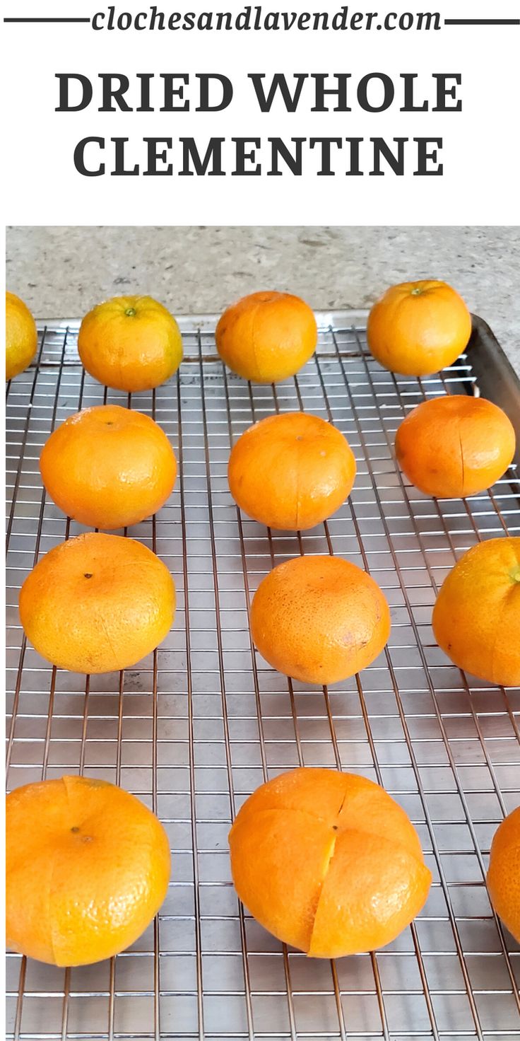 several oranges on a wire rack with the words dried whole clementine above them