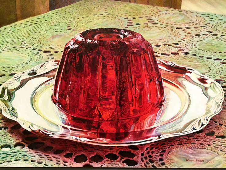 a red cake sitting on top of a glass plate