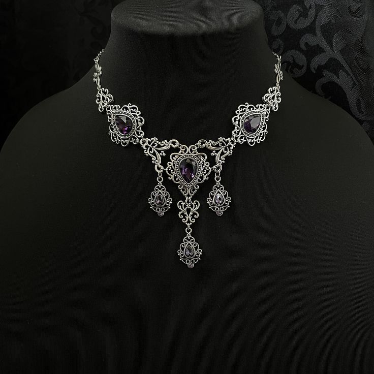 "This romantic necklace features richly detailed antiqued silver filigrees, scrolls and beaded accents. Adorned with sparkling dark amethyst purple glass crystals, its breath taking design will add Victorian elegance to your outfits. Decorated portion is 8 1/4\" wide and 2 3/4\" tall in the very center.  Necklace length is adjustable with soldered stainless steel cable chain, lobster clasp and extender. If you would like a different length, please send us a message. Matching headpiece and earrings are listed separately in our store. If you don't see items with a color you want, feel free to ask about availability." Rosary Chain Necklace, Purple Gothic, Antique Silver Necklace, Dark Amethyst, Romantic Necklace, Victorian Goth, Gothic Victorian, Costume Necklaces, Choker Pendant