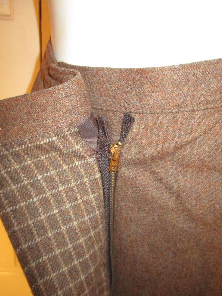 "This sharp suit is by Bert Newman for Suitime. It from from the late 1970's early 80's . It's 80% wool , 20% polyester. The jacket has 2 button side closure offset to one side with an interior snap. The skirt is a mock wrap with a center metal zipper and 2 buttons. The solid fabric is actually multi color tweed. I can see some plum and purple. The coordinating check fabric is on the collar and inside the skirt flap. The jacket has side pockets. No size tag but it is approx. size 2. The jacket m Winter Wool Skirt Suit For Business, Tailored Wool Skirt Suit, Mannequin Dress, Lounge Robes, Womens Suits, Check Fabric, Long Knit, Feb 8, Metal Zipper