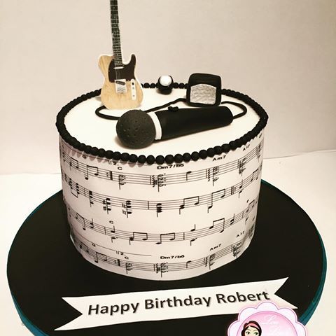 a birthday cake with musical instruments on it