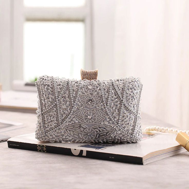 Captivating, Elegant, and Wedding-Ready – The Luxe Silver Wedding Clutch Bag is a showstopping accessory designed to elevate your bridal gown or wedding guest dress with whimsical beaded elegance. Featuring intricate silver beading and shimmering sequins, this silver wedding clutch bag exudes timeless sophistication and glamour for your most special occasions. Why We Love It...We adore the dazzling silver bead and sequin design that beautifully catches the light, adding a touch of opulence to an Silver Glamorous Evening Bag For Party, Elegant Sparkling Crystal Evening Bag, Glamorous Sequined Evening Bag For Weddings, Sparkling Silver Party Clutch, Silver Sequined Clutch Bag, Silver Sequined Clutch Evening Bag, Luxury Silver Embellished Evening Bag, Glamorous Rectangular Sequined Evening Bag, Silver Rectangular Evening Bag With Sequins