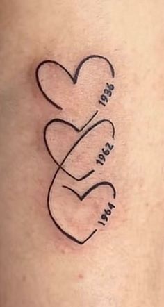 a tattoo on the back of a woman's stomach with two hearts in it