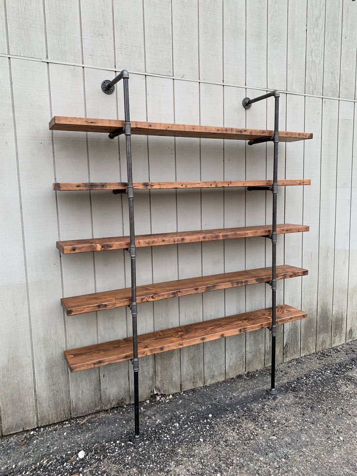 an industrial style shelving unit in front of a wall