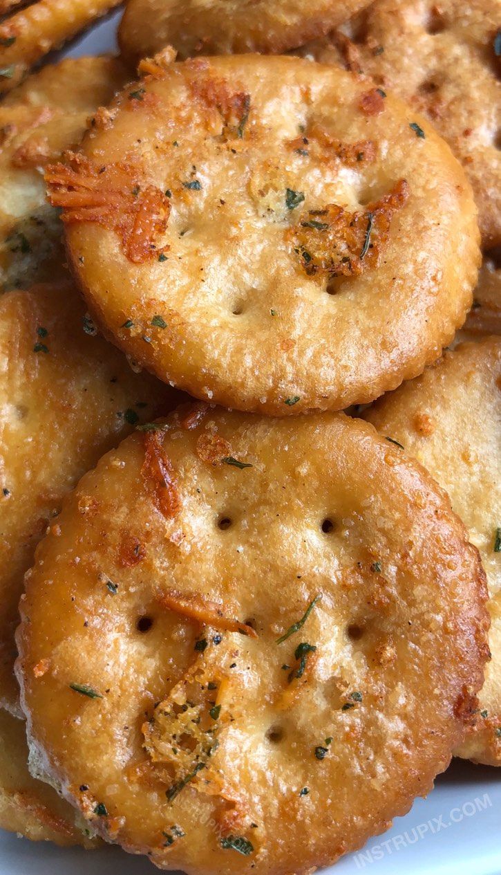 some fried food on a white plate with parmesan and seasoning sprinkles