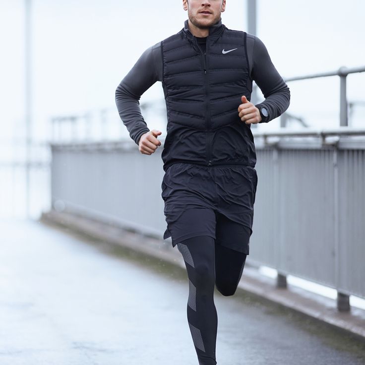 a man is running on the street in the rain