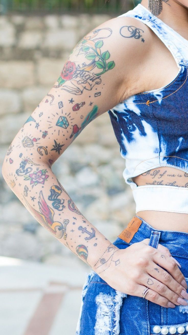 a woman with tattoos on her arms and chest