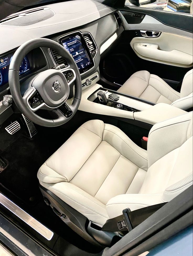 the interior of a car with white leather seats