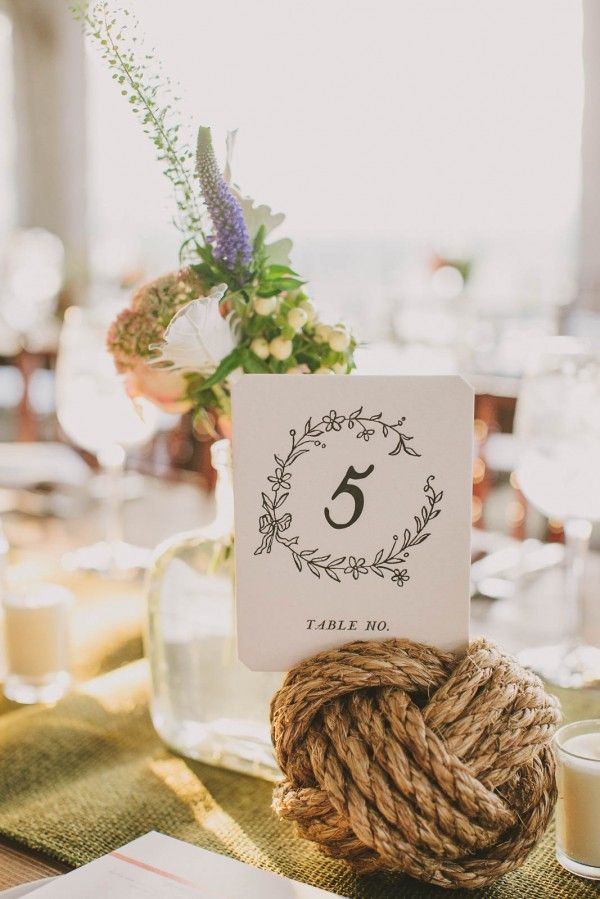 the table numbers are placed on top of twine