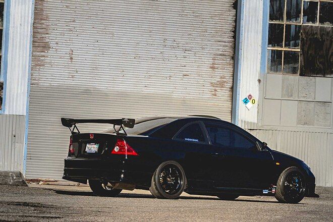 a black car parked in front of a building