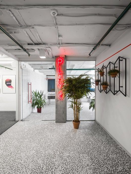 an empty office with plants and potted plants on either side of the door way