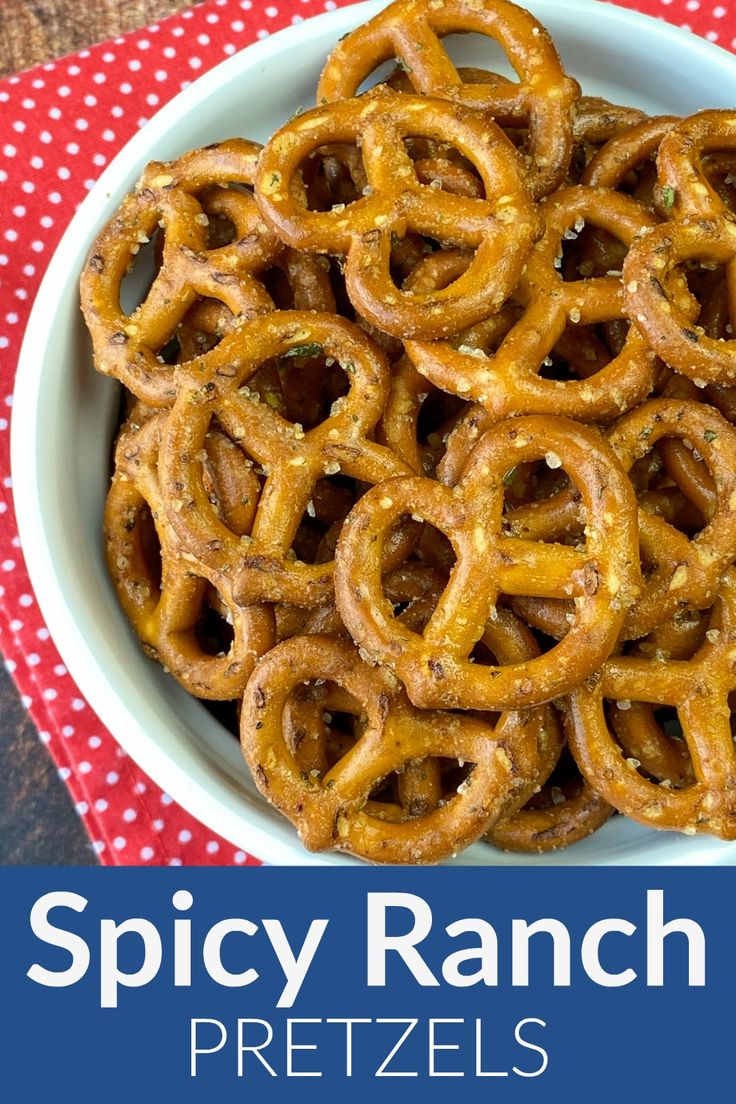 a bowl full of spicy ranch pretzels on top of a red and white napkin