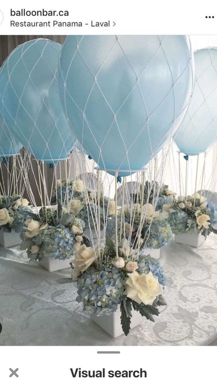 blue balloons and white flowers on a table