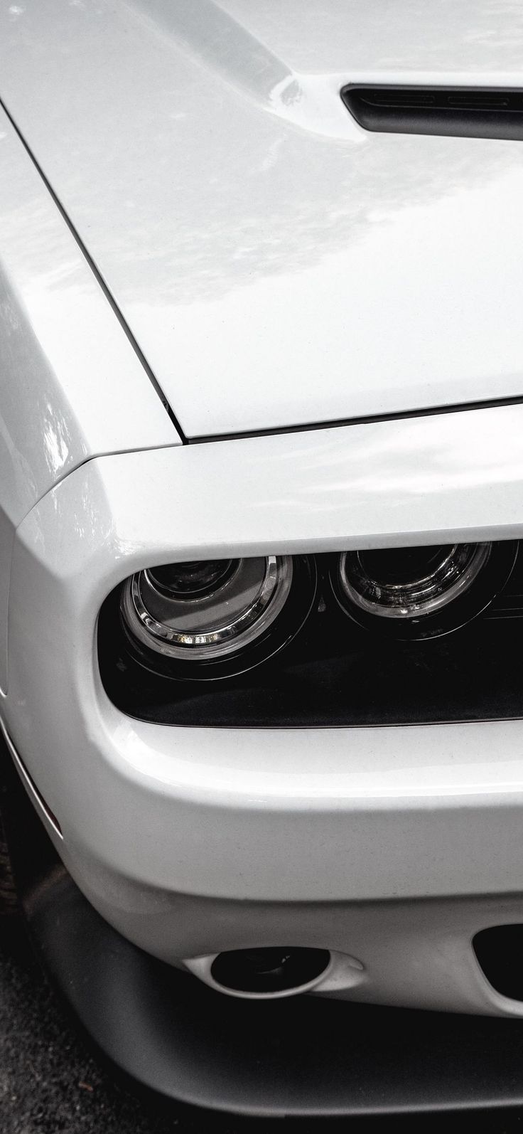 the front end of a white sports car