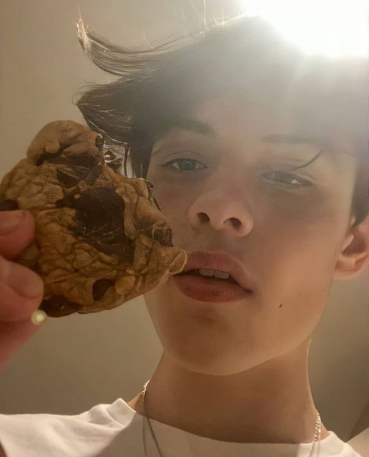 a person holding a cookie up to their face