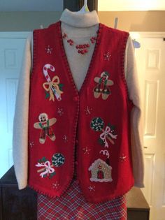 a red sweater vest with christmas decorations on it