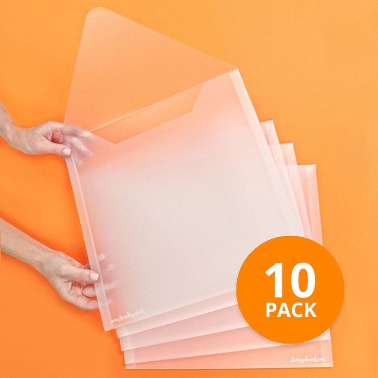 a person holding some clear plastic sheets on top of an orange surface