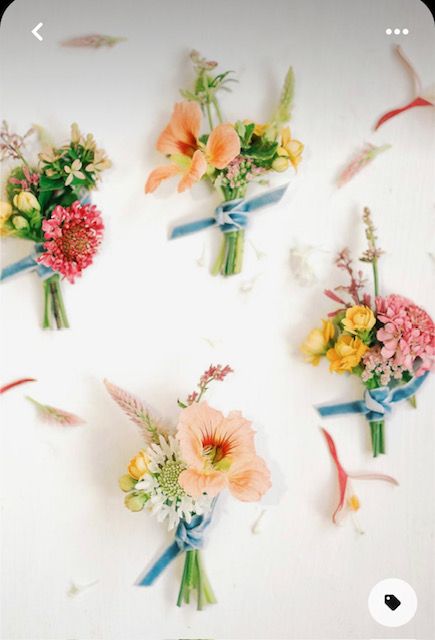 flowers are arranged on the wall with ribbons