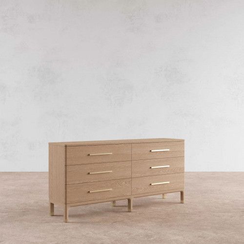 a large wooden dresser sitting on top of a carpeted floor next to a white wall