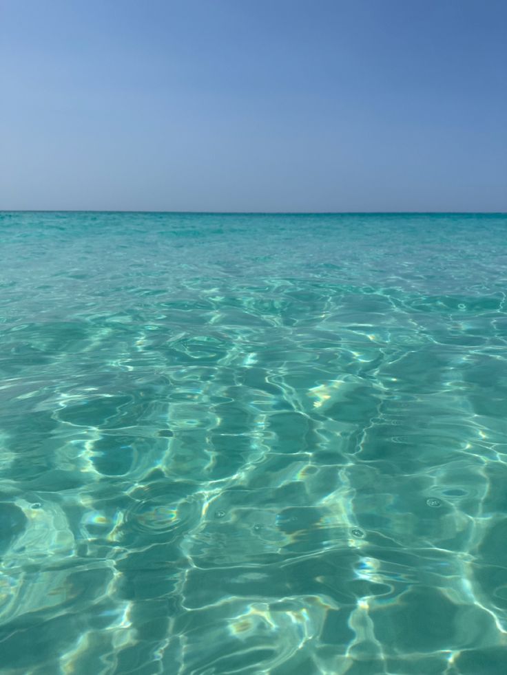 the water is very clear and blue with little ripples on it's surface