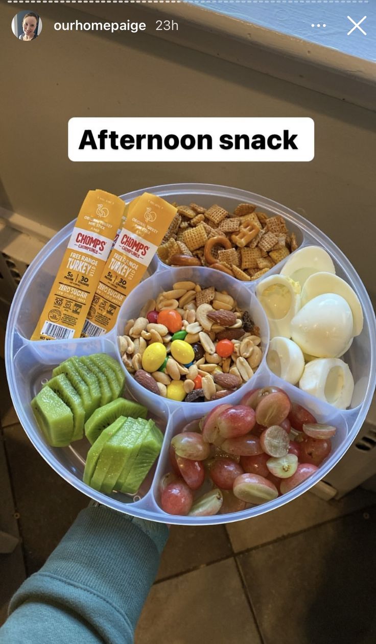 someone is holding a tray with different foods in it and the caption reads afternoon snack