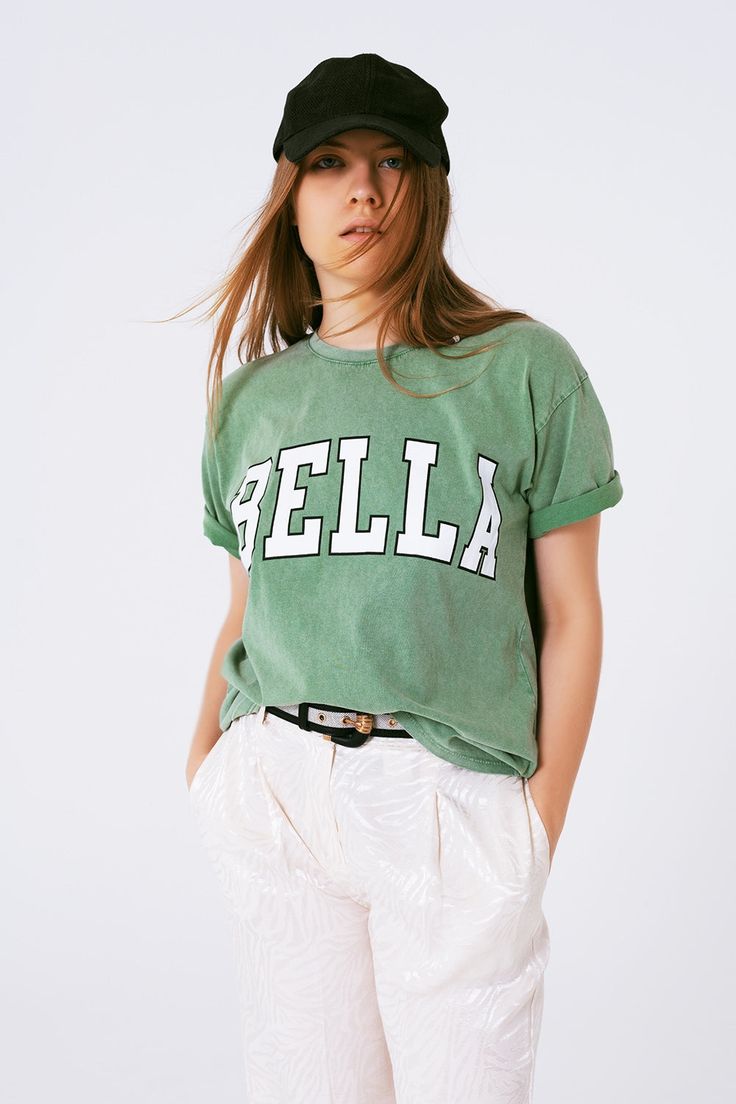 Q2 T-Shirt with Bella Text in green Chic Oversized T-shirt For Everyday, Chic Cotton T-shirt For Fall, Chic Cotton T-shirt With Graphic Print, Sporty Cotton T-shirt For Spring, Relaxed Fit Tan T-shirt With Text Print, Trendy Green T-shirt For Fall, Trendy Crew Neck Top With Screen Print, Spring Graphic Tee Cotton Tops, Spring Cotton Graphic Tee Tops