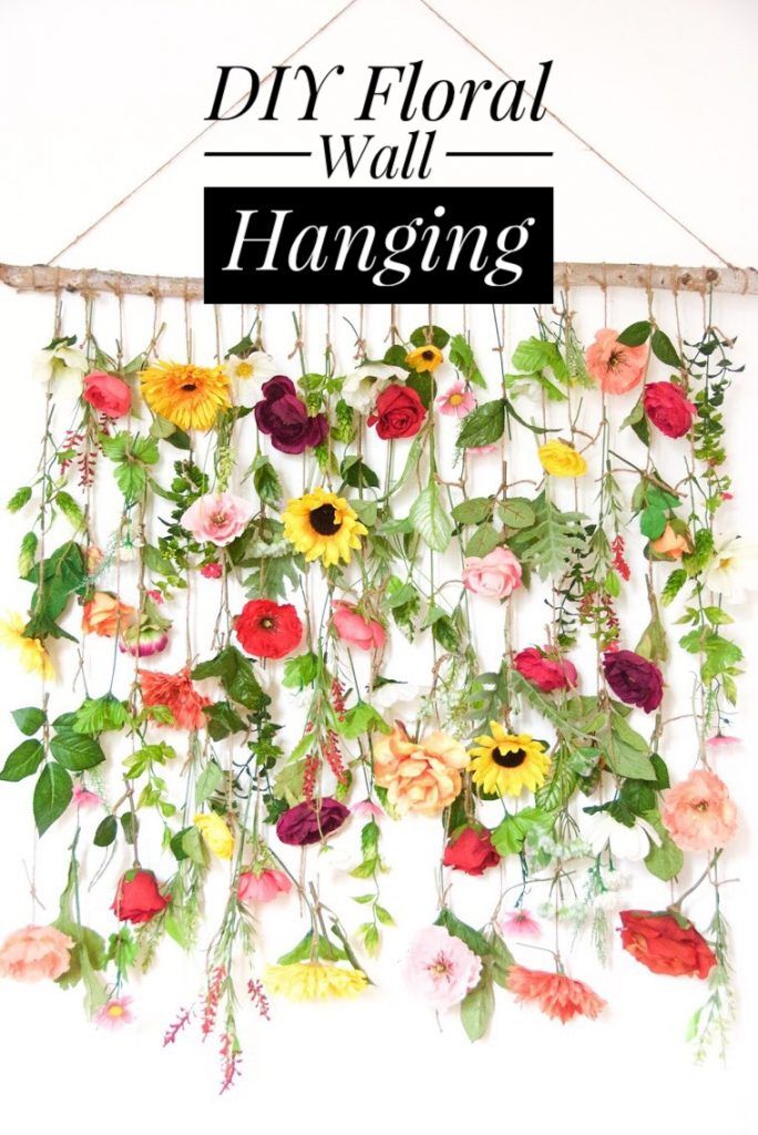 a wall hanging made out of flowers and leaves with the words diy floral wall hanging