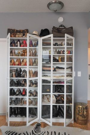 a closet filled with lots of shoes and purses next to a zebra print rug