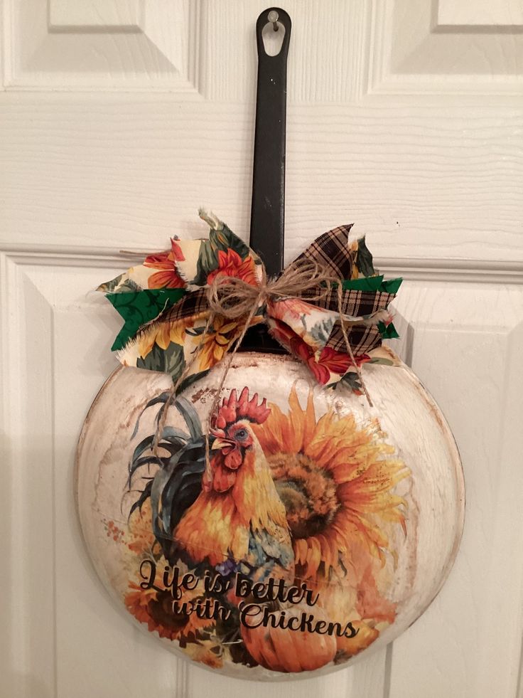 a door hanger decorated with an image of a rooster and sunflowers