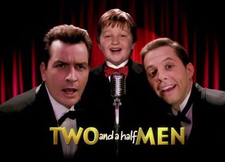 two and half men appearing in front of a microphone