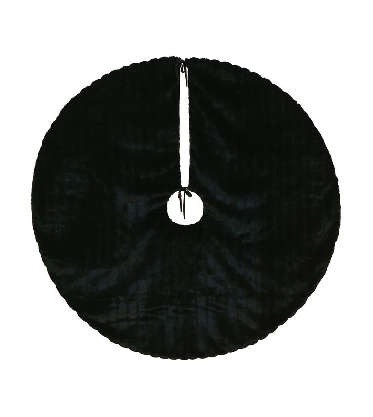 a black round object with a white circle in the middle