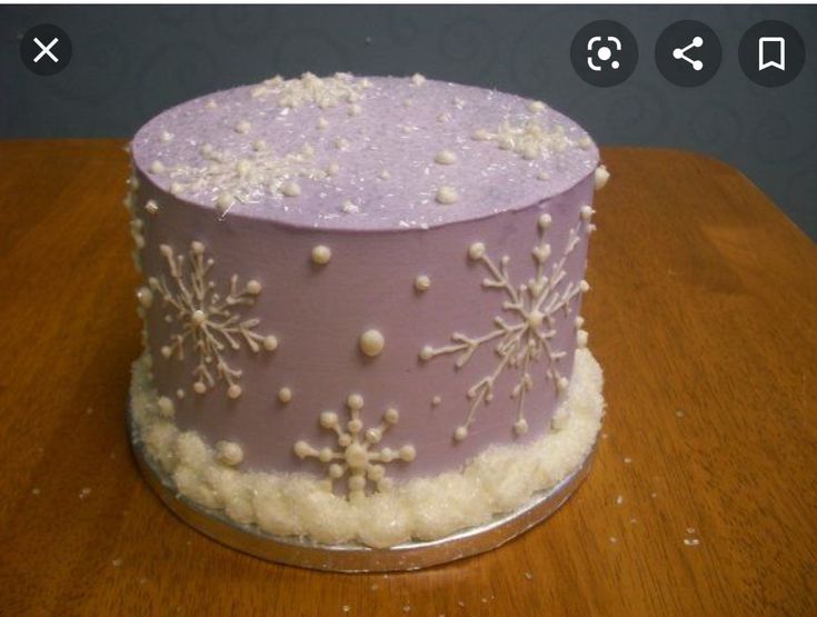 a purple cake with white snowflakes on it