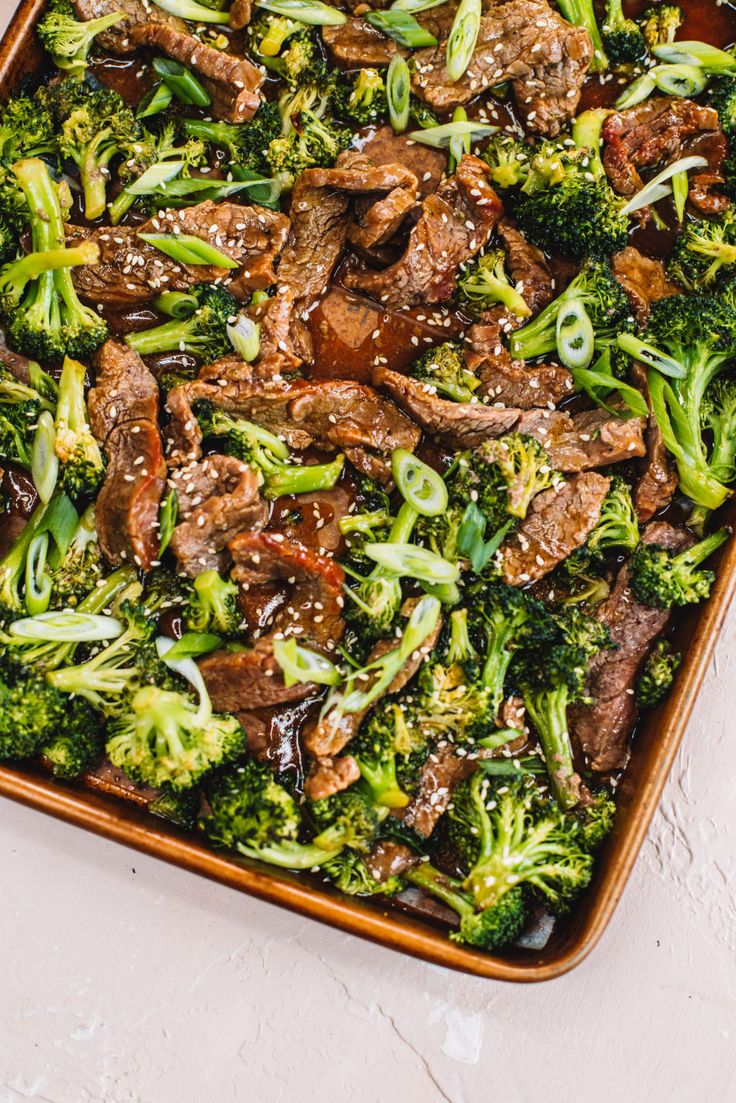 a casserole dish with broccoli and beef