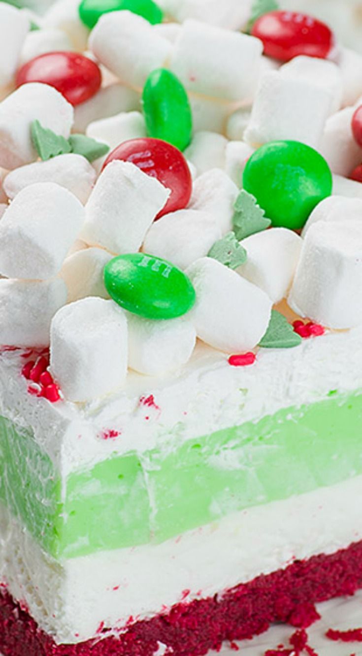 a close up of a cake with candy and marshmallows on it's top