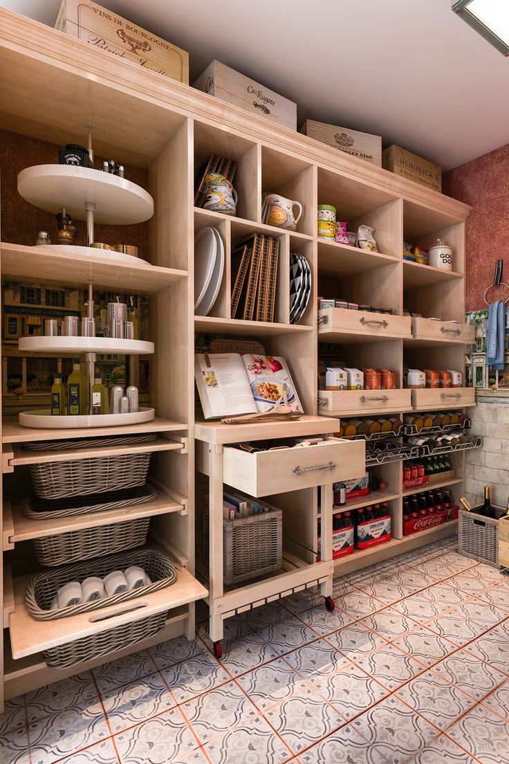 a kitchen with lots of wooden shelves filled with dishes