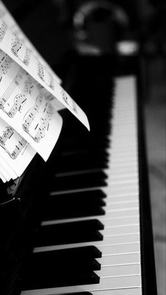 sheet music sitting on top of a piano