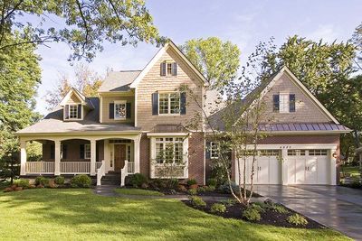 a large house with two car garages in the front yard