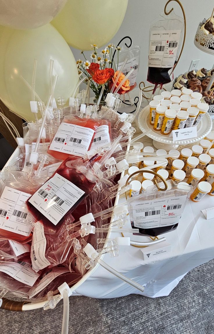 an assortment of desserts on a table with balloons in the background at a party