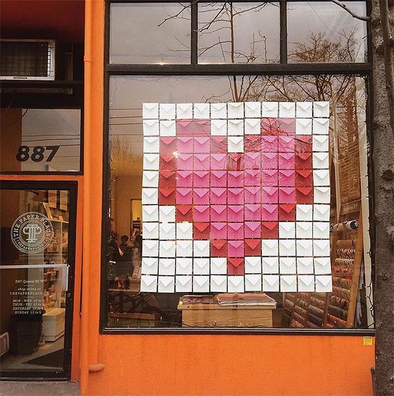 a pink heart is in the window of a store