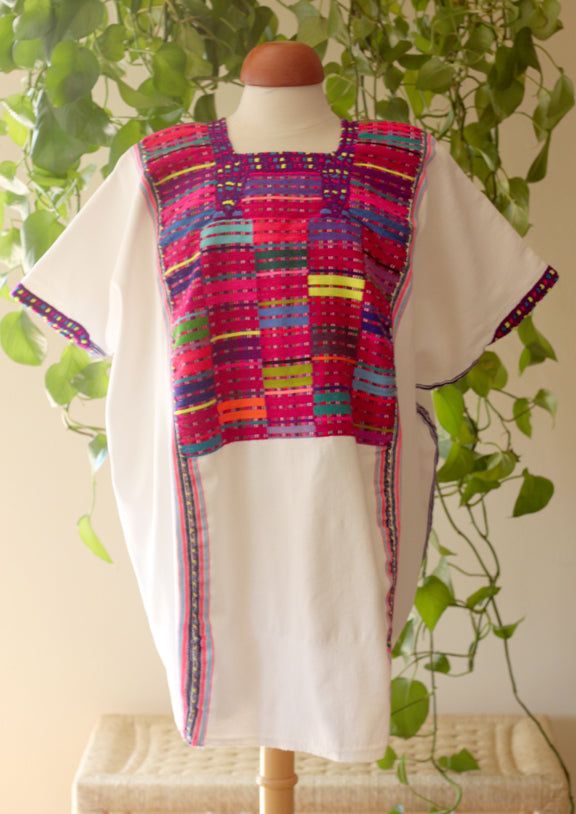 This exquisite tunic, also known as a Huipil, the traditional garment worn by Maya women, was made in the village of San Juan Cancuc in Chiapas. This huipil was hand woven from 100% cotton and embroidered using a traditional technique from the region. Textiles of this quality are rare finds, and are never duplicated so you will never find another one just like this. This garment measures 78cm long by 88cm wide, it is intended to have a loose, open fit. Traditional Cotton Kaftan With Woven Motifs, White Traditional Tops With Traditional Patterns, Bohemian Blouse With Traditional Patterns For Ceremonies, Traditional White Short Sleeve Tunic, Traditional Multicolor Tunic For Festivals, Multicolor Embroidered Cotton Folk Kaftan, Bohemian Multicolor Blouse For Traditional Ceremonies, Multicolor Bohemian Blouse For Traditional Ceremonies, Folk Style Cotton Kaftan With Multicolor Embroidery