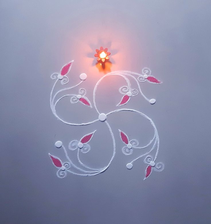 an artisticly designed wall light with red and white flowers in the shape of a heart