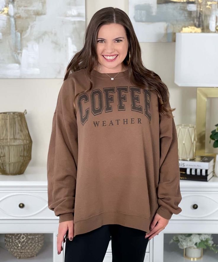 Introducing our Coffee Weather Sweatshirt, the perfect cozy companion for embracing those crisp and chilly days. Whether you're heading to your favorite coffee shop, enjoying a leisurely stroll in the park, or simply lounging at home with a warm cup of java, this sweatshirt celebrates your love for both comfort and caffeine.
The words "coffee weather" are elegantly displayed in black on an army brown sweatshirt. Available in sizes ranging from S to 5XL, our sweatshirt ensures a comfortable and relaxed fit for everyone.
Embrace the essence of fall and winter with the inviting warmth of your go-to coffee and the cozy comfort of our sweatshirt. The soft fabric and casual silhouette make it an ideal addition to your casual wardrobe, while the stylish design adds a touch of flair to your everyd Comfy Leisure Tops For Fall, Coffee Long-sleeve Sweatshirt For Winter, Casual Coffee-colored Winter Sweatshirt, Casual Coffee Sweatshirt For Winter, Casual Coffee Sweatshirt For Fall, Coffee Letter Print Tops For Fall, Coffee Colored Tops With Letter Print For Fall, Relaxed Fit Coffee Color Tops For Fall, Winter Weekend Tops With Relaxed Fit