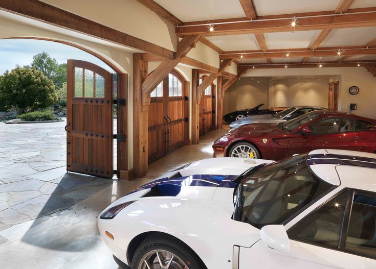 a garage with several cars parked in it and an open door leading to another room